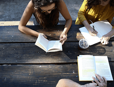 Some of our students studying at one of our outdoor tables on campus.